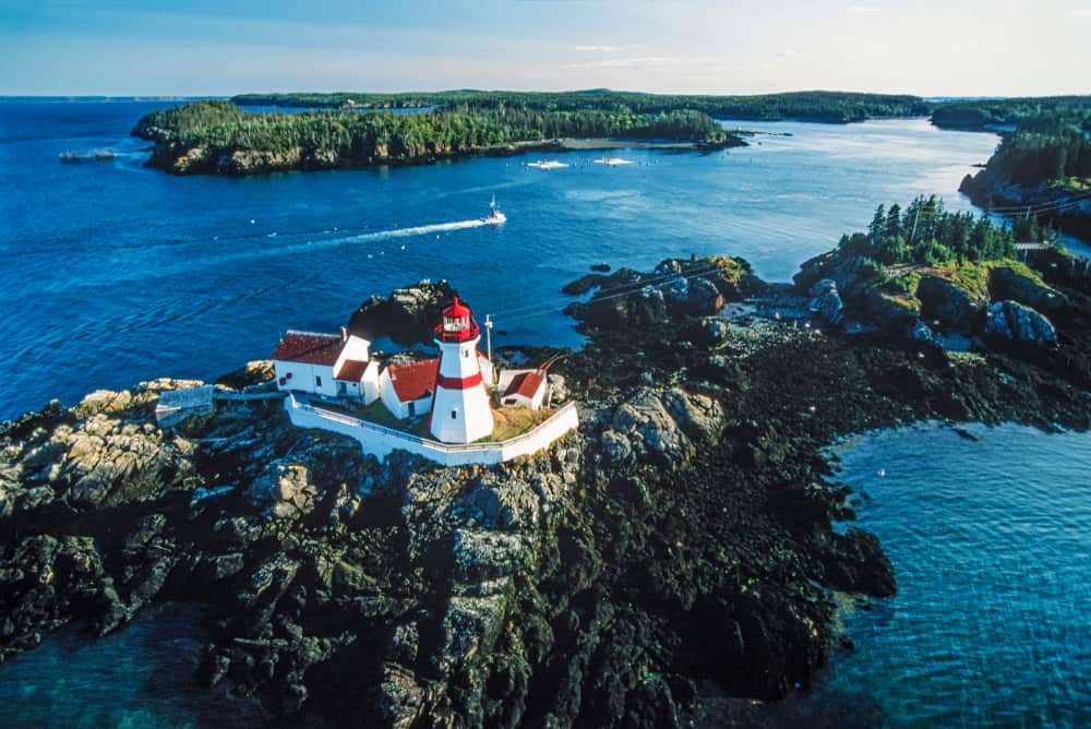 An aerial view of a lighthouse on a rocky island in New Brunswick.