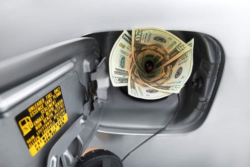 A dollar bill is being pumped into a gas pump by RVers in response to high fuel prices.