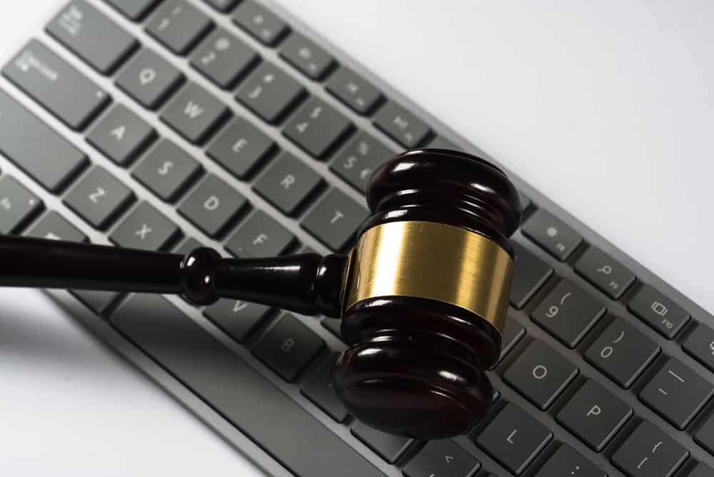 A judge's gavel resting beside a computer keyboard at an online auction for BCLCA.