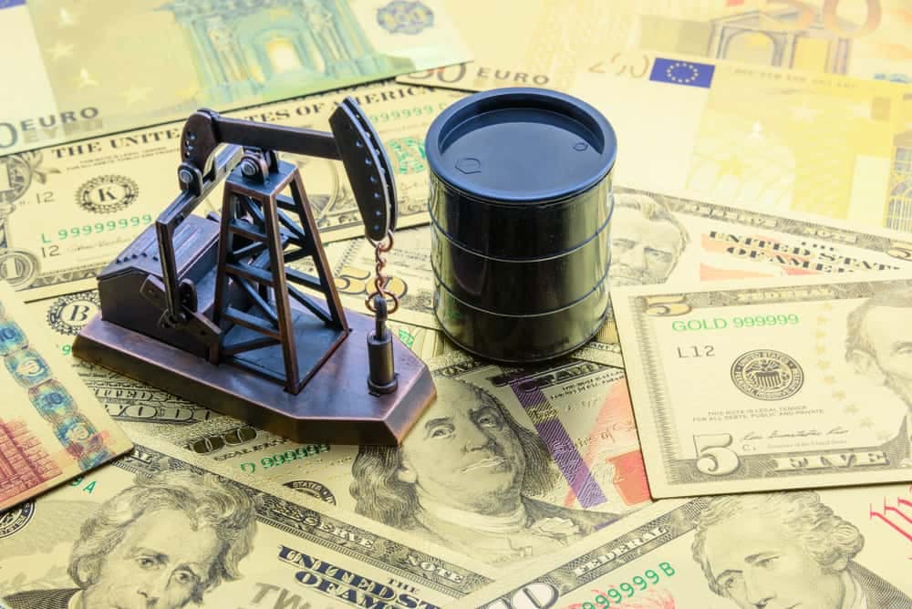 Oil pump on a pile of money amidst the slide in oil prices.