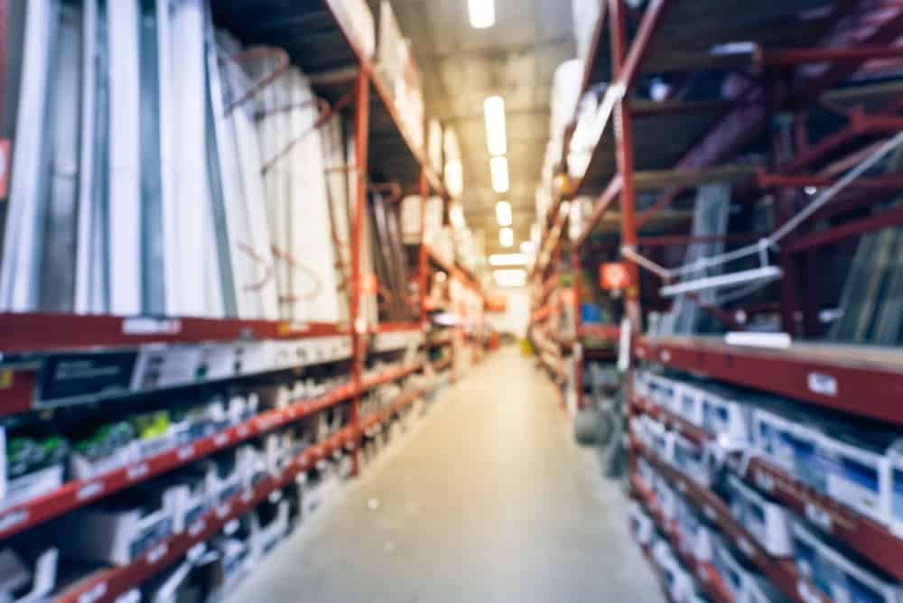A blurry image of wholesale inventories on store shelves.