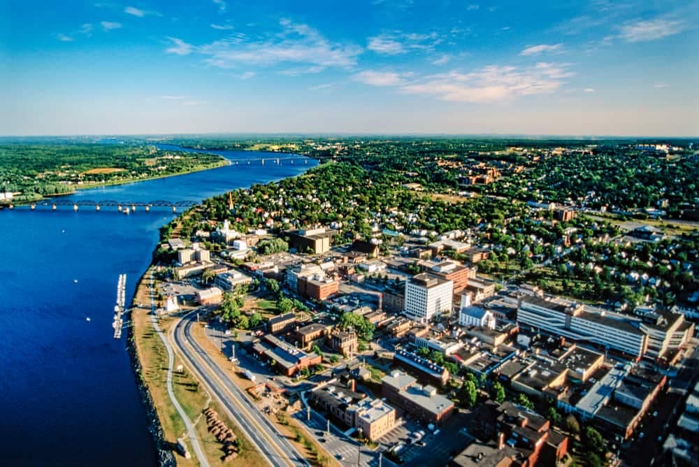 A post-pandemic aerial view of a tourism city near a river in New Brunswick.