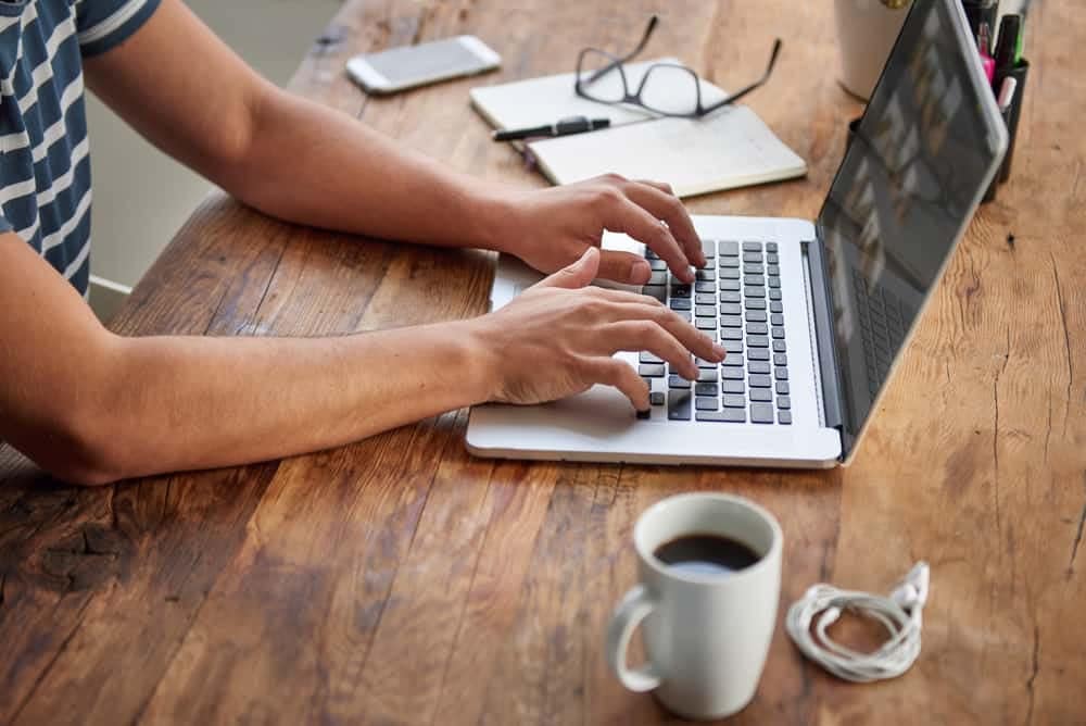 A man experiencing unmatched convenience types on a laptop at a desk.