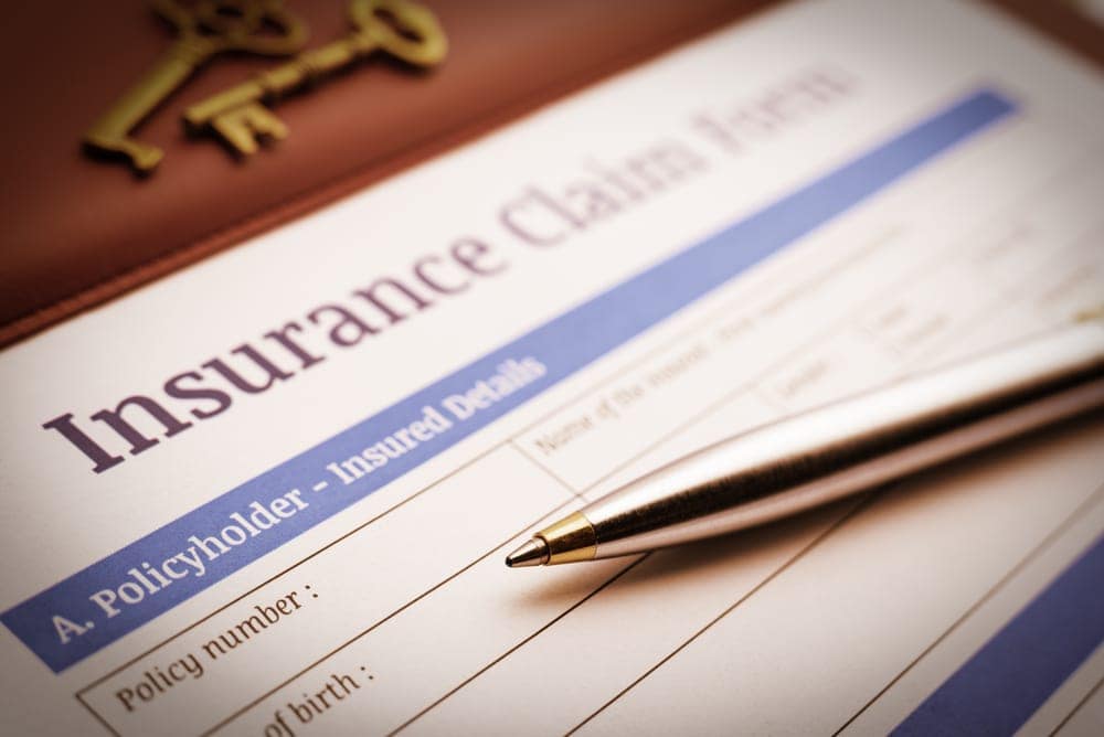 An Australian pen rests on top of an insurance claim form.