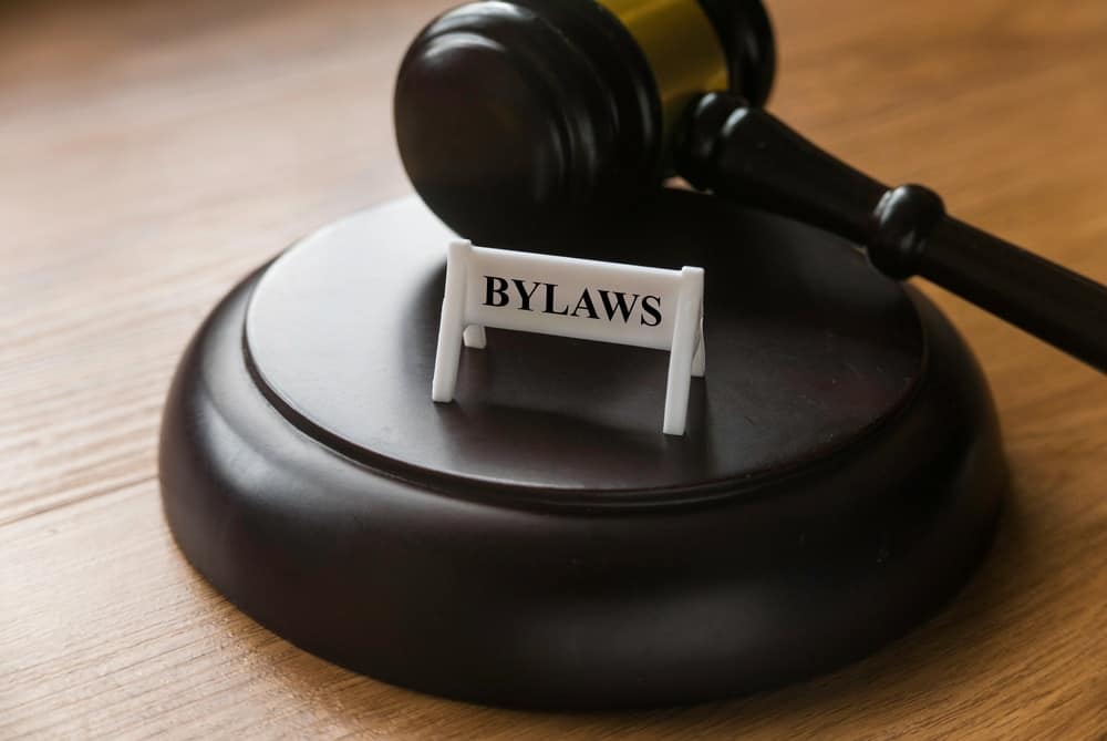 A wooden gavel with the word "bylaws" on it, symbolizing the power to amend regulations in a B.C. City related to RVs.
