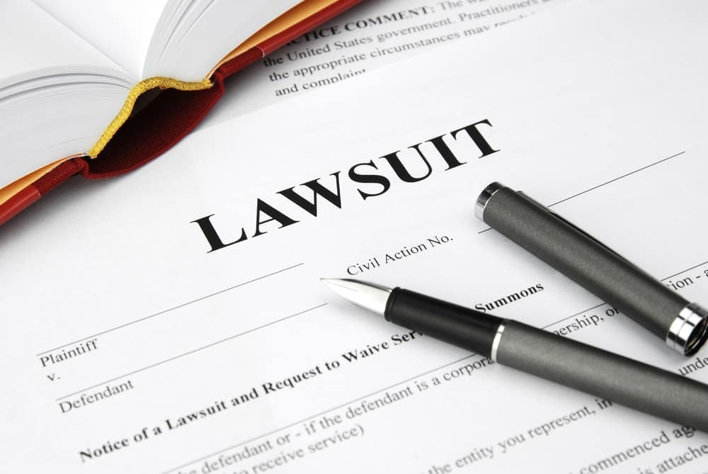 A legal document with an illegal expansion lawsuit filed at the New York RV Park, with a pen on top of it.
