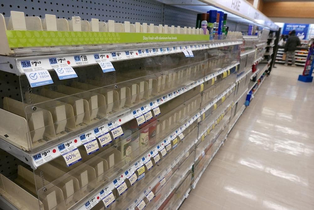 A row of empty shelves in a drug store, raising concerns of exploitation and prompting an investigation by the U.S. Justice Dep't.