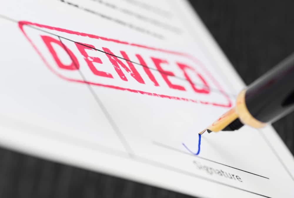 A pen is being used to write the word rejected on a document regarding illegally demolished Punch Bowl Inn's land at Caravan Park.