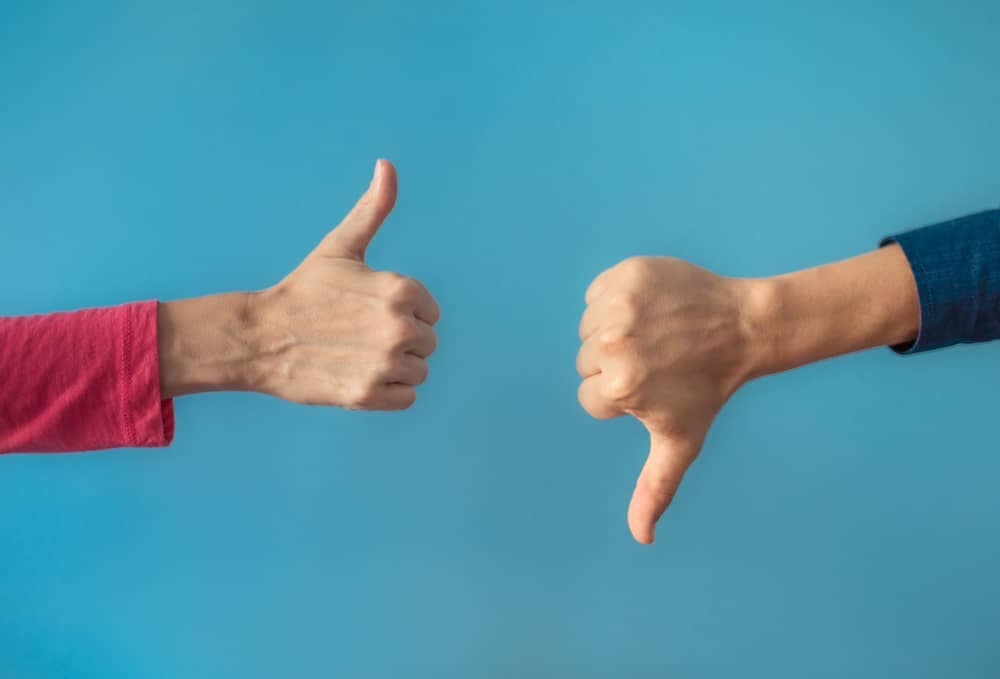 Two people, representing industry-wide standards, demonstrating thumbs up and thumbs down on a blue background to park operators.