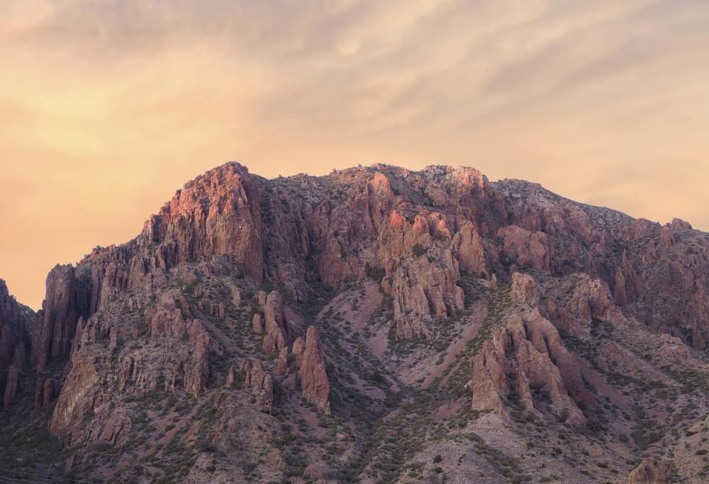 A majestic mountain with a cloudy sky in the background, located in Big Bend National Park.