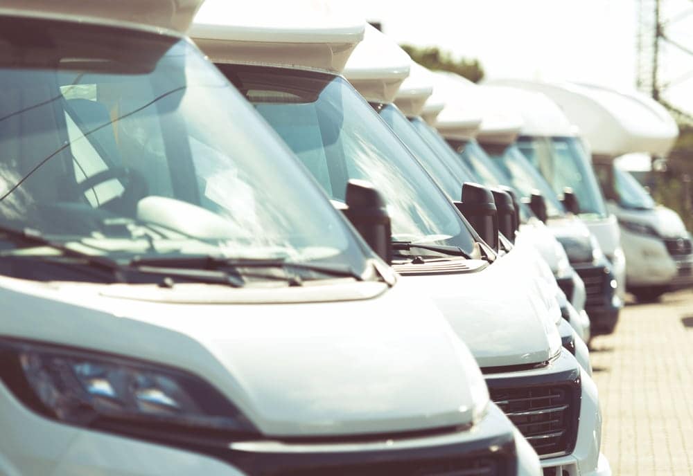A row of white RVs parked next to each other at Keller Marine & RV, showcasing their partnership in motility.