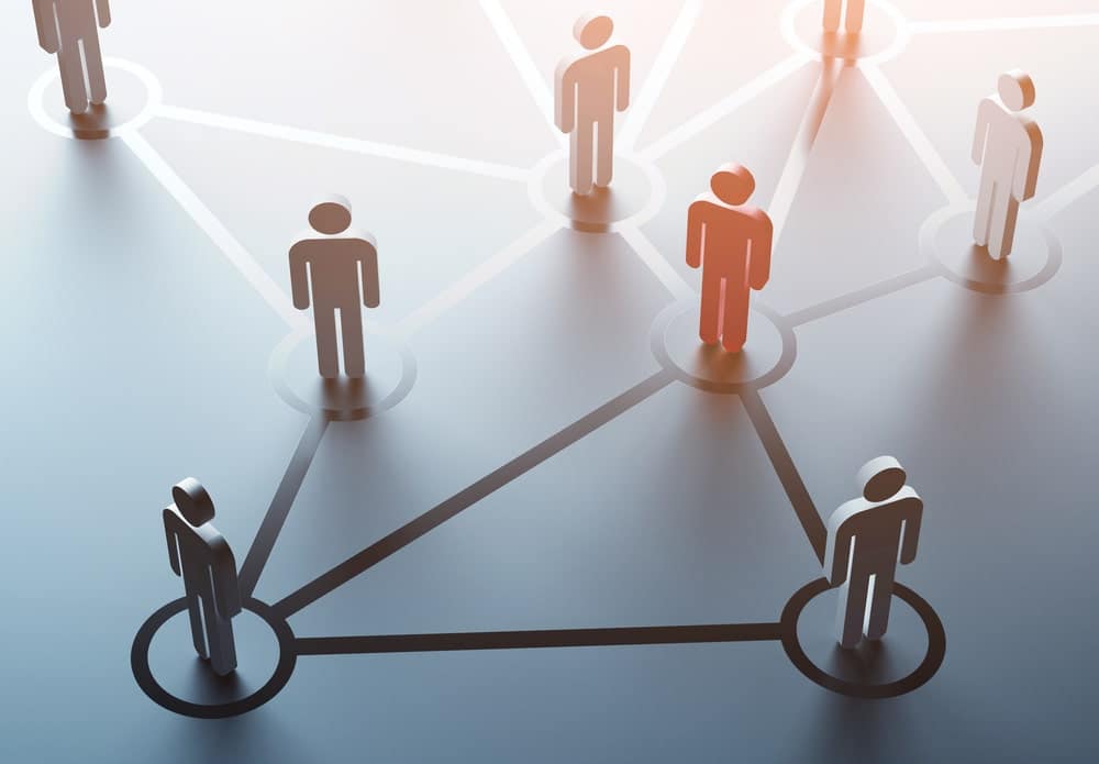 A group of people with a red person standing in the middle of a network at the 2021 Convention.