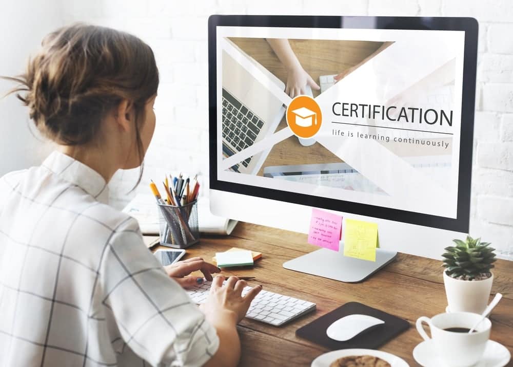 A woman gazing at a computer screen displaying her certified RV Professional certification.