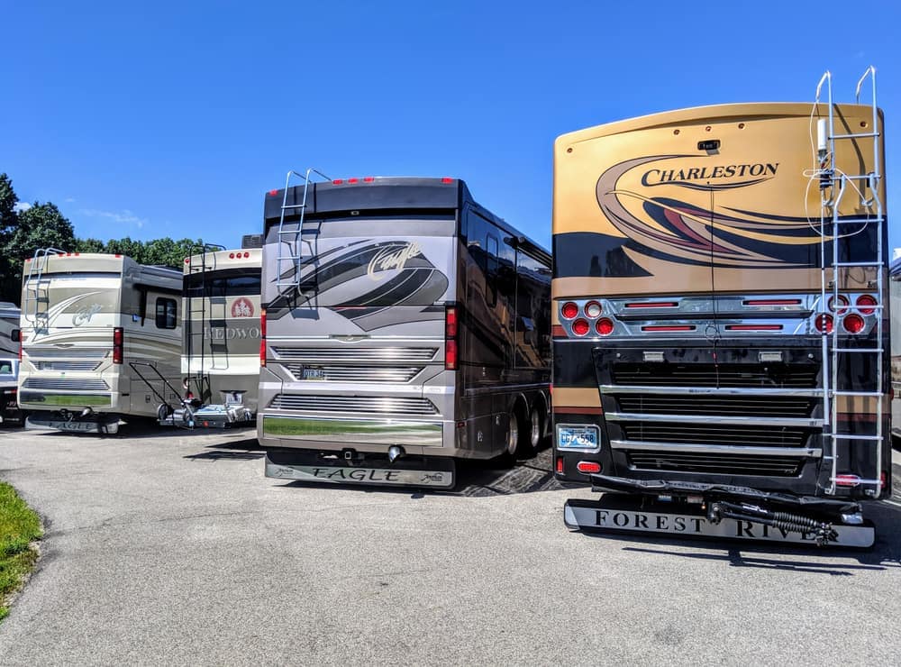 A group of RVs parked in a parking lot, showcasing the current state of the RV industry.