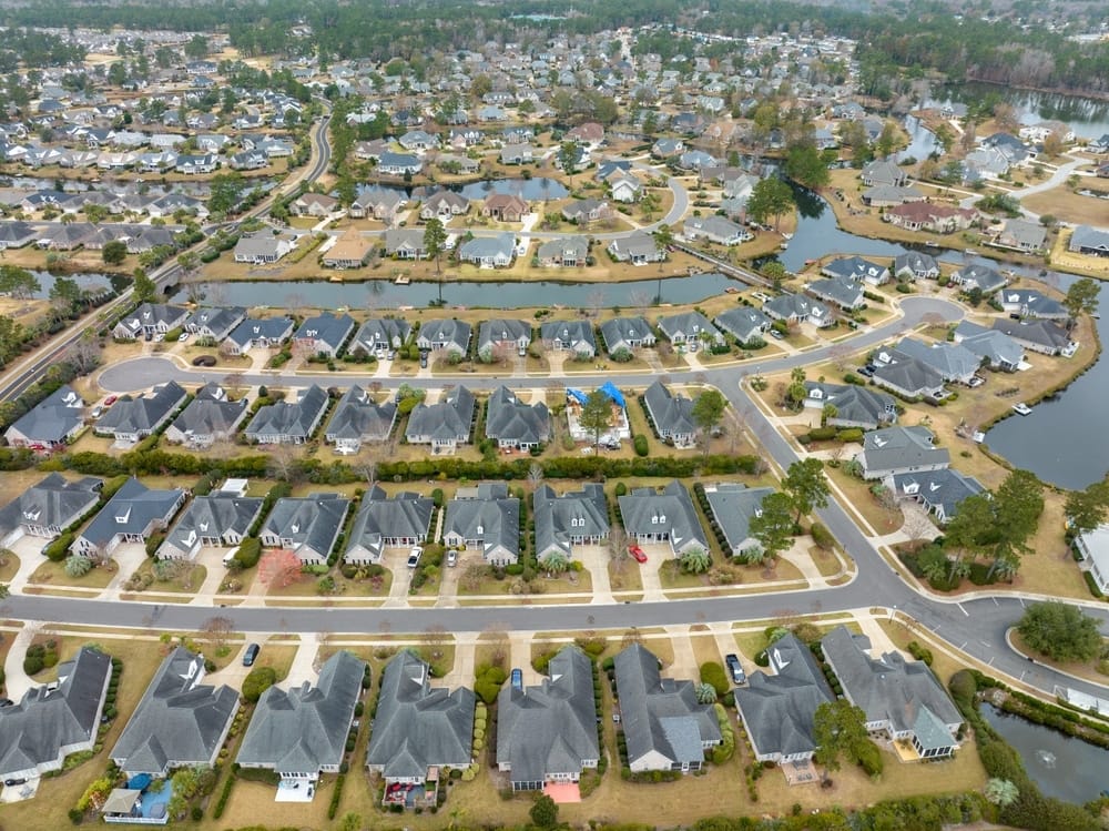 An aerial view of a residential neighborhood with flooding concerns.