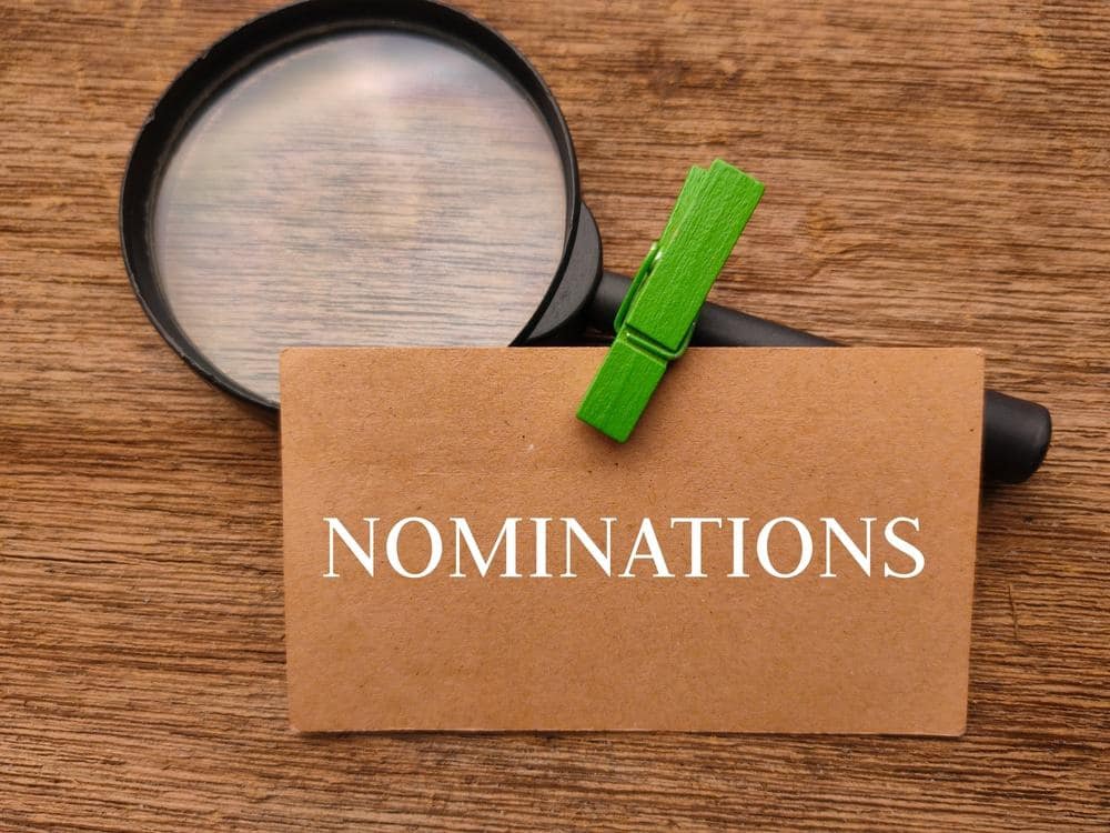 The word nominations on a piece of paper with a magnifying glass at the CCRVC conference.