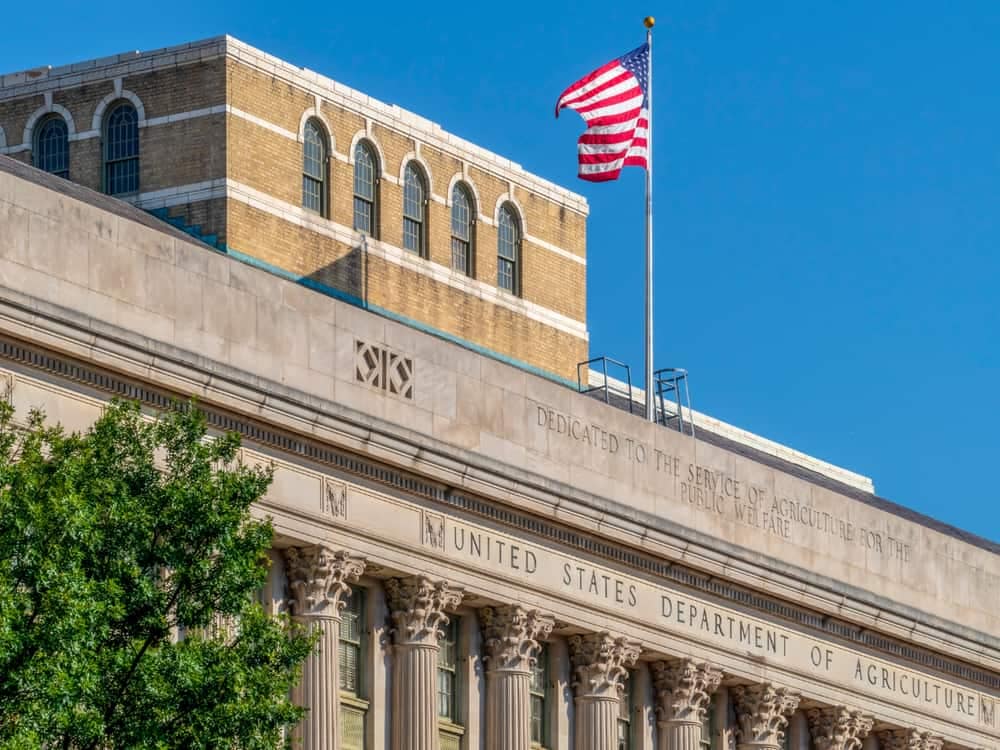 An American flag proudly flies on top of a building showcasing outdoor rec.