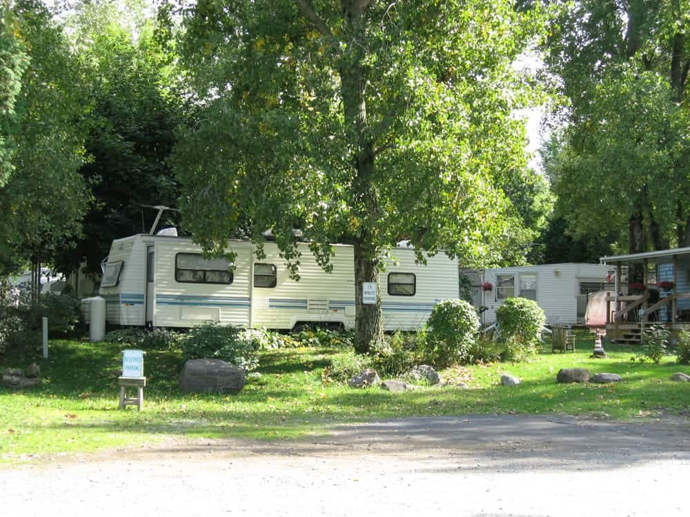 A white RV parked in a grassy area near North Country Campgrounds.