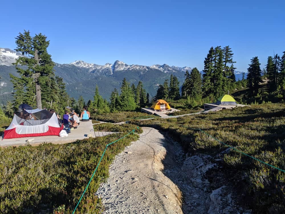 A campground with a group of tents set up on the trail to Garibaldi Lake.