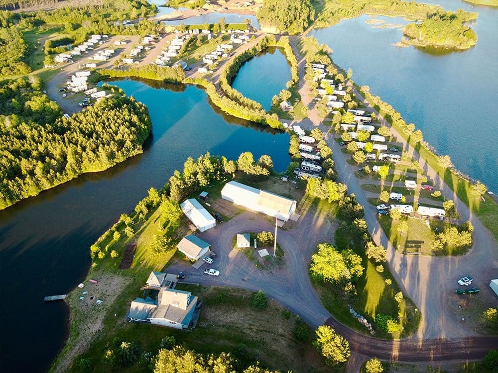 Red Pine Campground, with its rustic charm, offers an aerial view of an rv park near a lake.