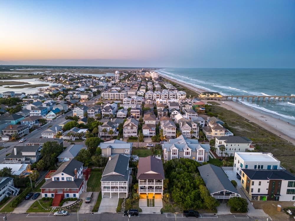 An aerial view of a beach town at dusk, featuring the RV Campground and One Tree Hill Way.