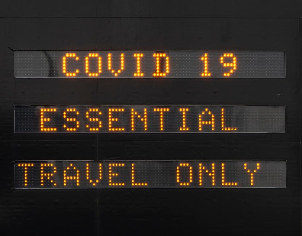 A sign on Highway 3 that reads "covid 19 essential travel only.