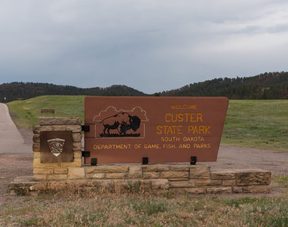 The private campground owner at Custer State Park implements an expansion plan with the installation of a new sign at the park's entrance.