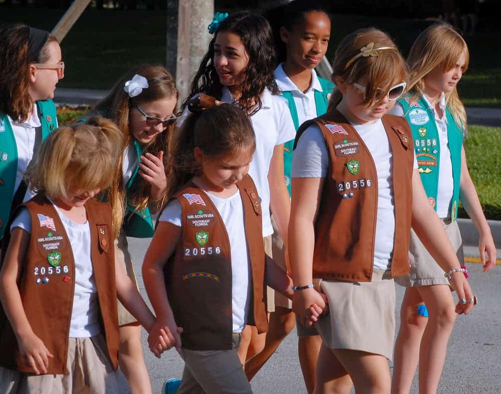 A group of Girl Scouts, in partnership with THOR Ind., walking down the street.