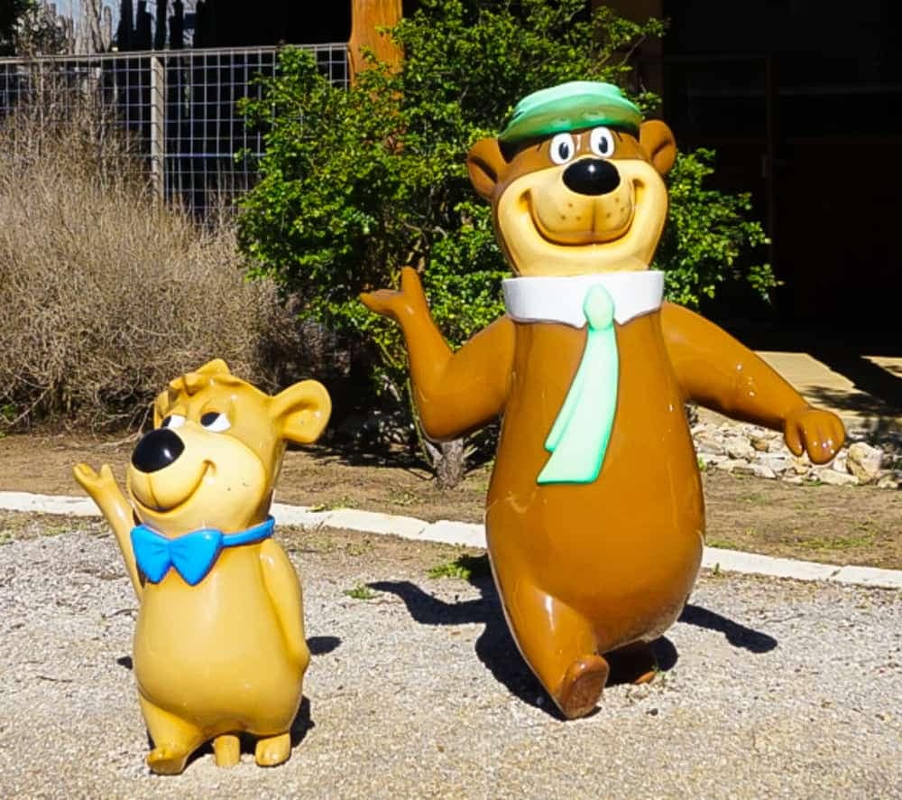 Two statues of a bear and a teddy bear standing next to each other expand to new locations, including Yogi Bear's Jellystone Park.