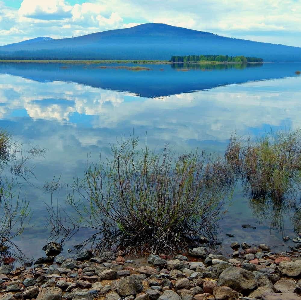 A mountain is reflected in a body of water at an Oregon campground.