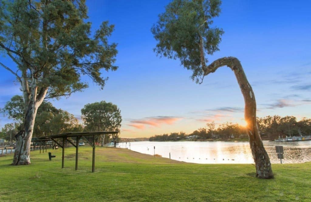 A Caravan Park nestled in the Mid Murray region, surrounded by lush trees and featuring a picturesque lake in the background.