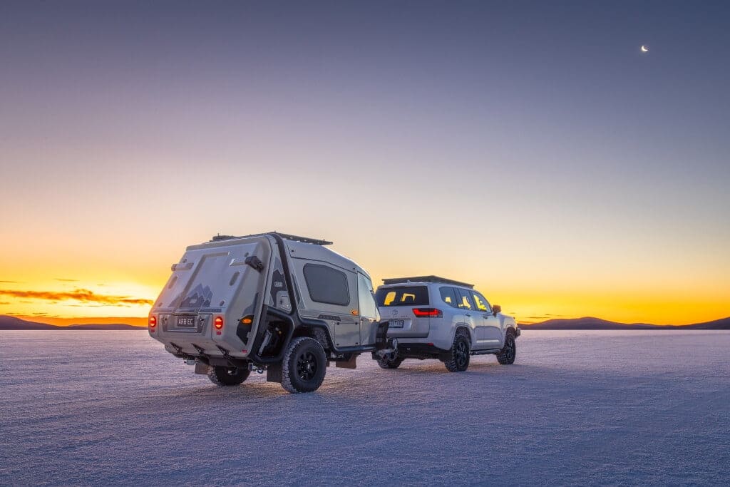An ARB Earth Camper and a jeep are parked in the desert.