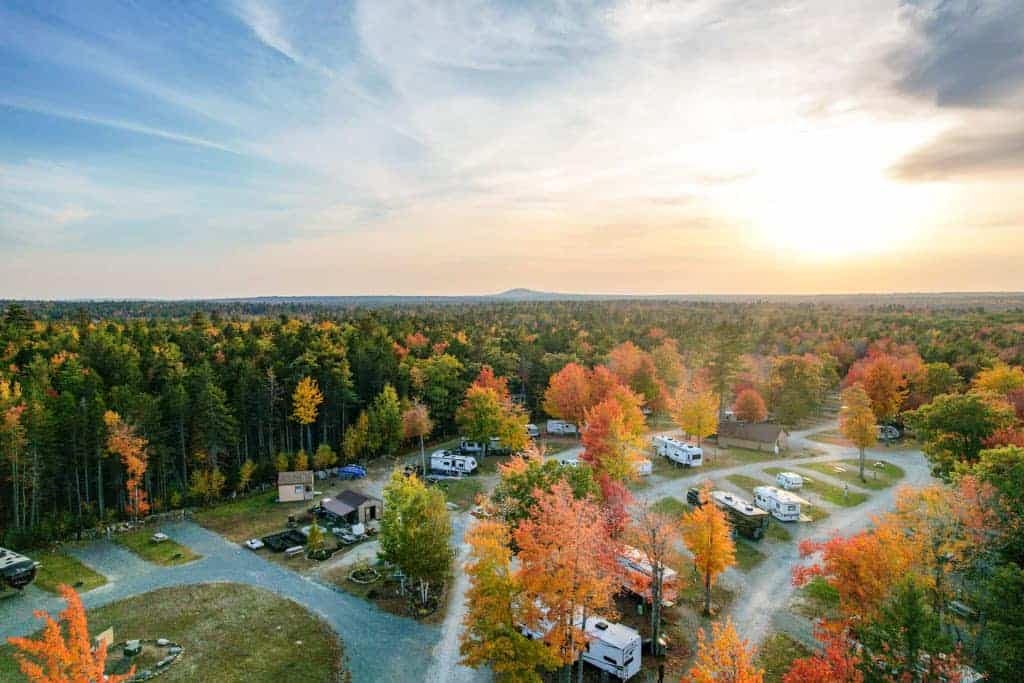 Experience a breathtaking sunset over the Forest Ridge Campground with an enchanting aerial view of the RV park.
