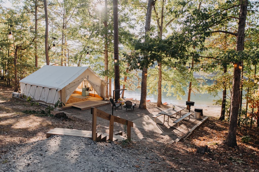 An upscale outdoor lodging tent sits in the woods next to Lake Allatoona.