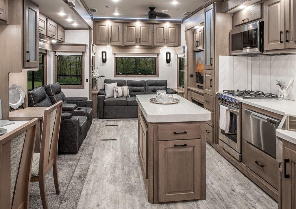 The Chai Hickory interior of an RV with a spacious kitchen and cozy living room, showcasing stylish interior design.