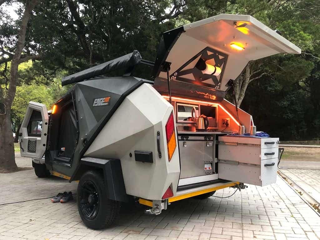 A molded teardrop trailer with a kitchen inside.