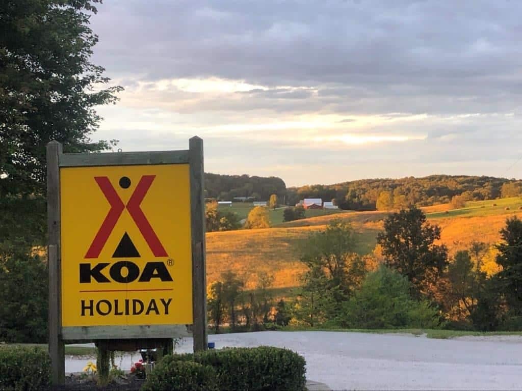 Koa Holiday campground sign in front of a field at Hocking Hills.