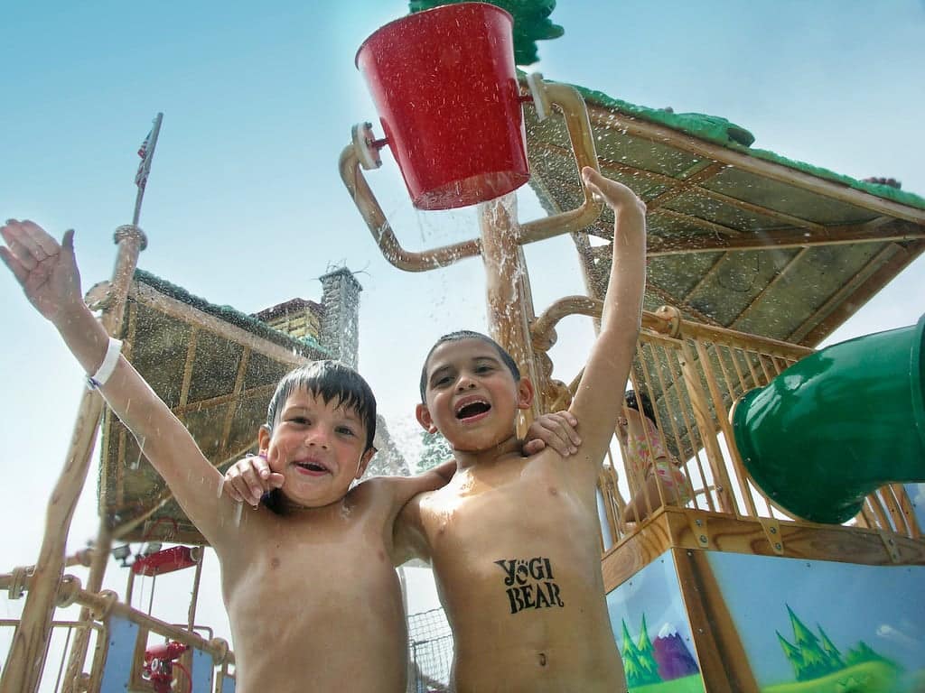 Two boys standing in front of a lakefront water park in Wisconsin.