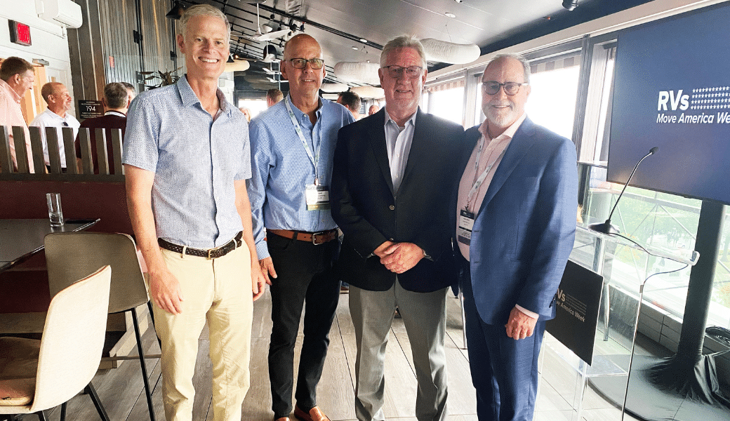Four men from the RV industry, including Jeff Rutherford, standing next to each other at an event.