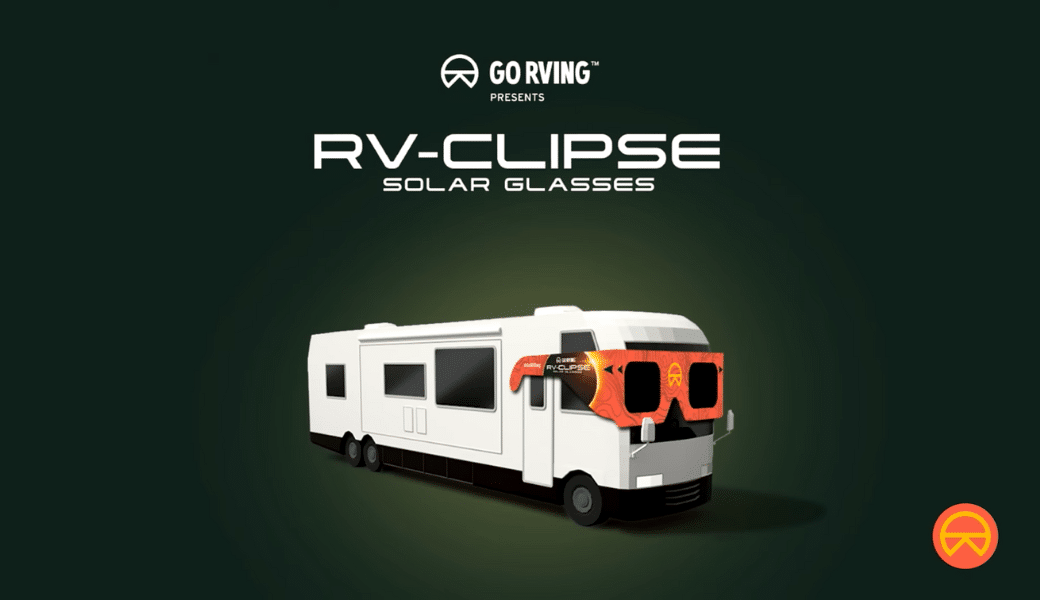 An RV with oversized solar eclipse glasses displayed on a green background, for an “RV-eclipse” advertisement.