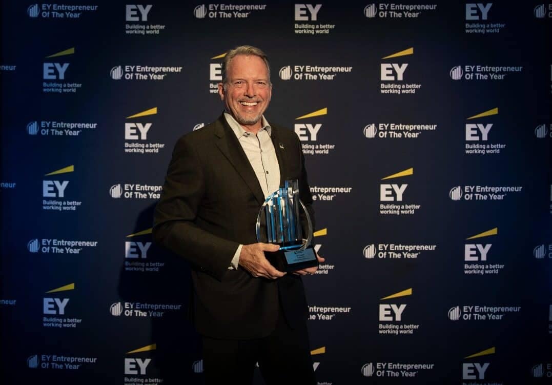 The President of Shyft Group, dressed in a suit, proudly holding an eye award.
