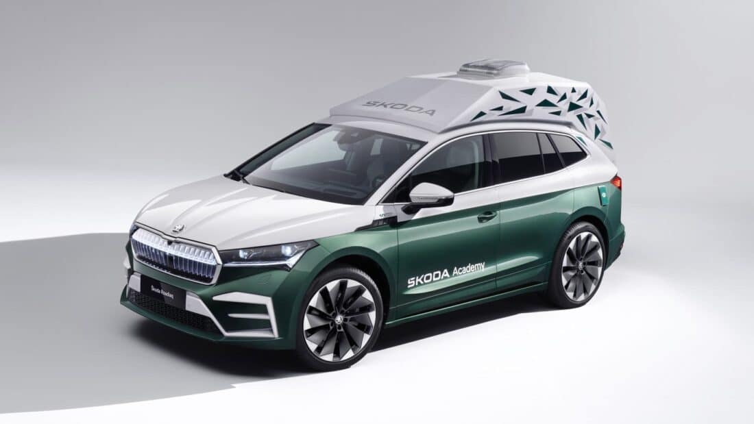 A green and white SUV with a mobile office for digital nomads, featuring a bird on the roof.