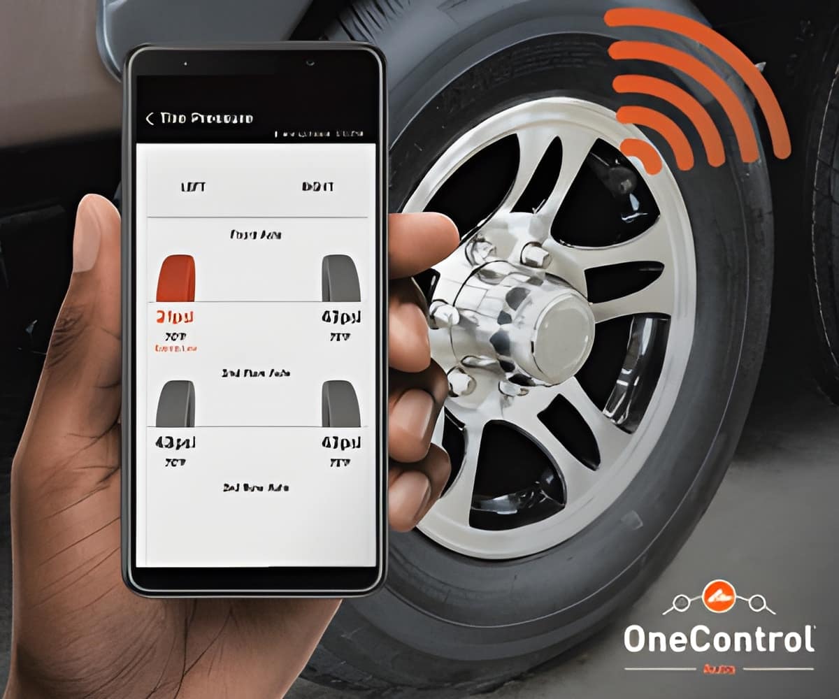 A person holding a smartphone with the word one control on it, enhancing the towing experience with Lippert's OneControl Auto App.