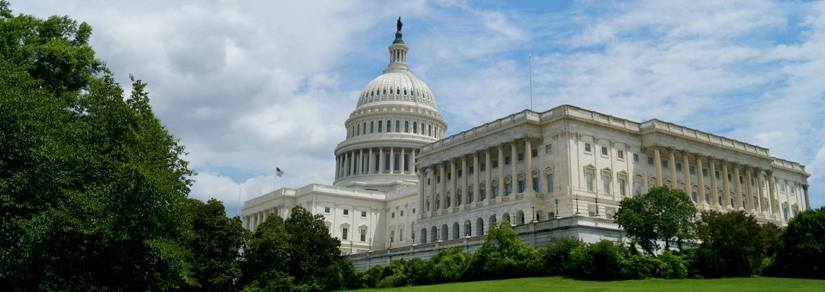 A white building with a dome and a statue on top, showcasing the impressive architecture of infrastructure legislation.
