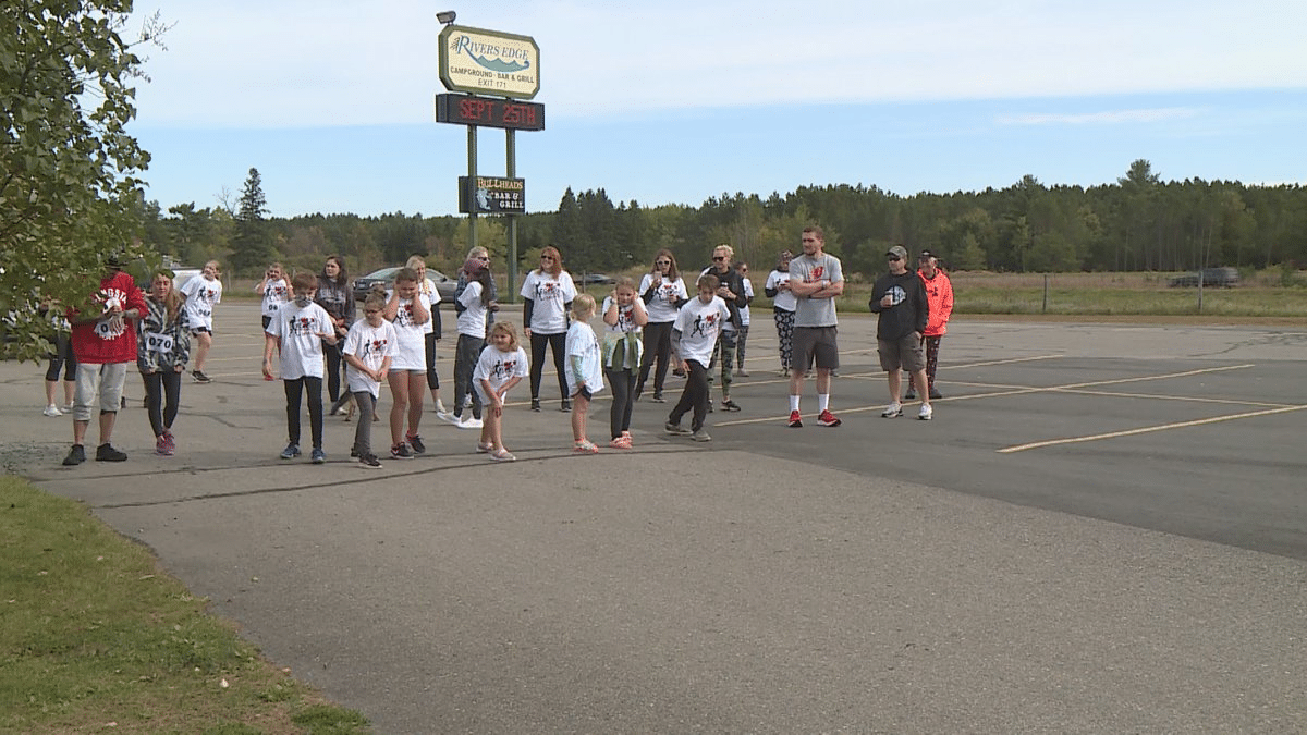 A group of people spooked in a parking lot.