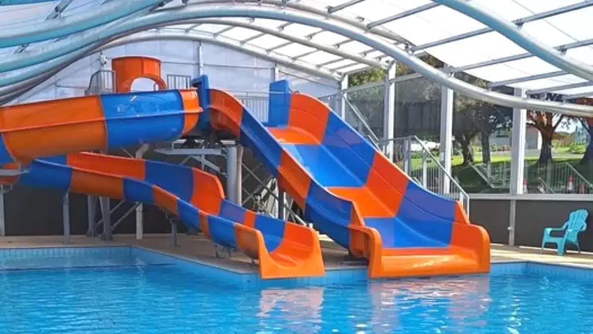 An orange and blue water slide located in the indoor heated pool at Blue Lake Holiday Park in Mount Gambier.