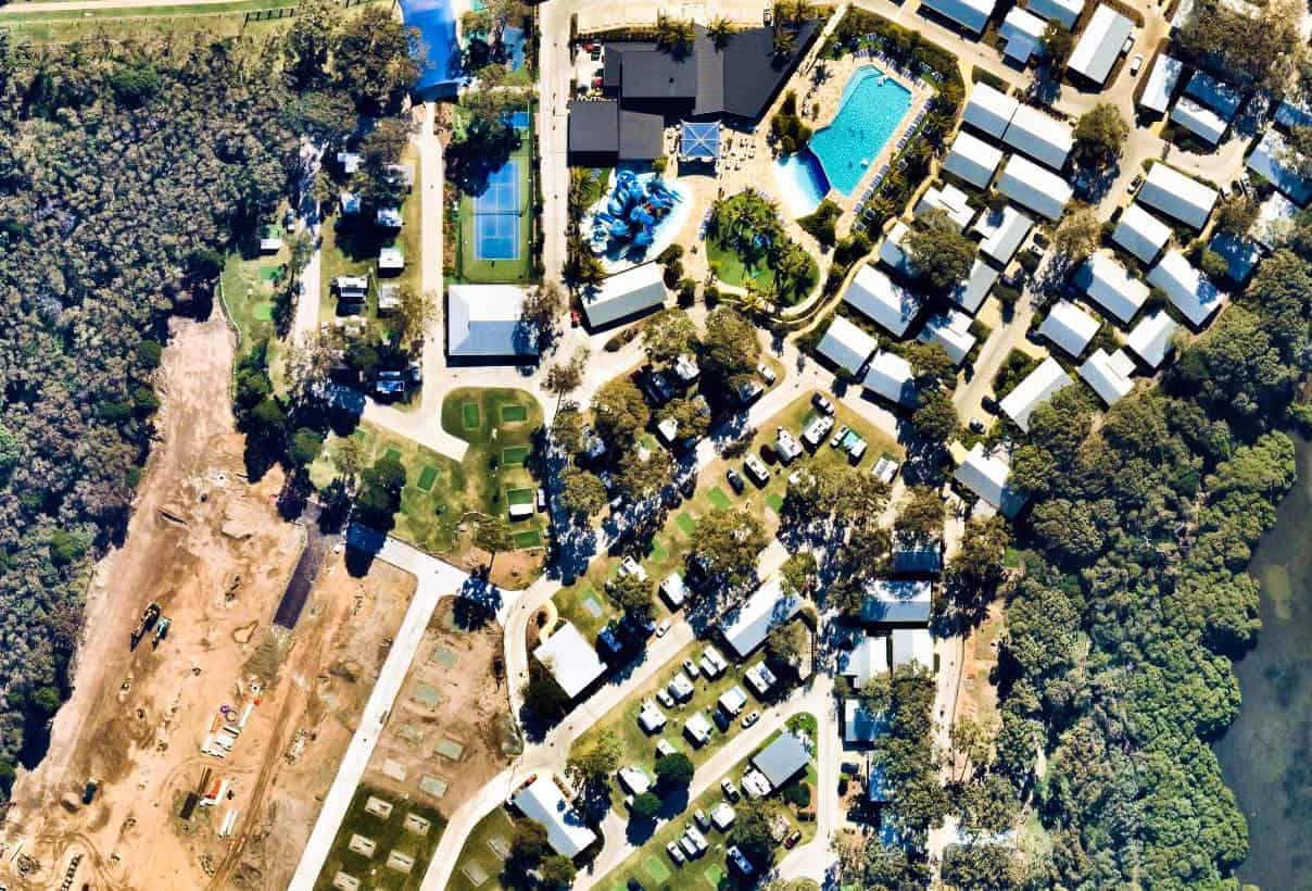 People enjoying a holiday resort from an aerial view, surrounded by nature and embracing the joy of camping.