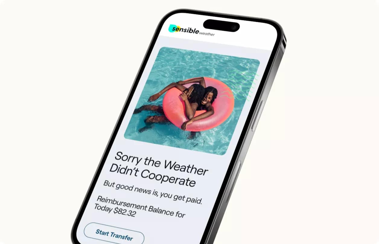 A smartphone displaying a message about weather-related reimbursement with a background image of a person floating on an auto draft pool ring.