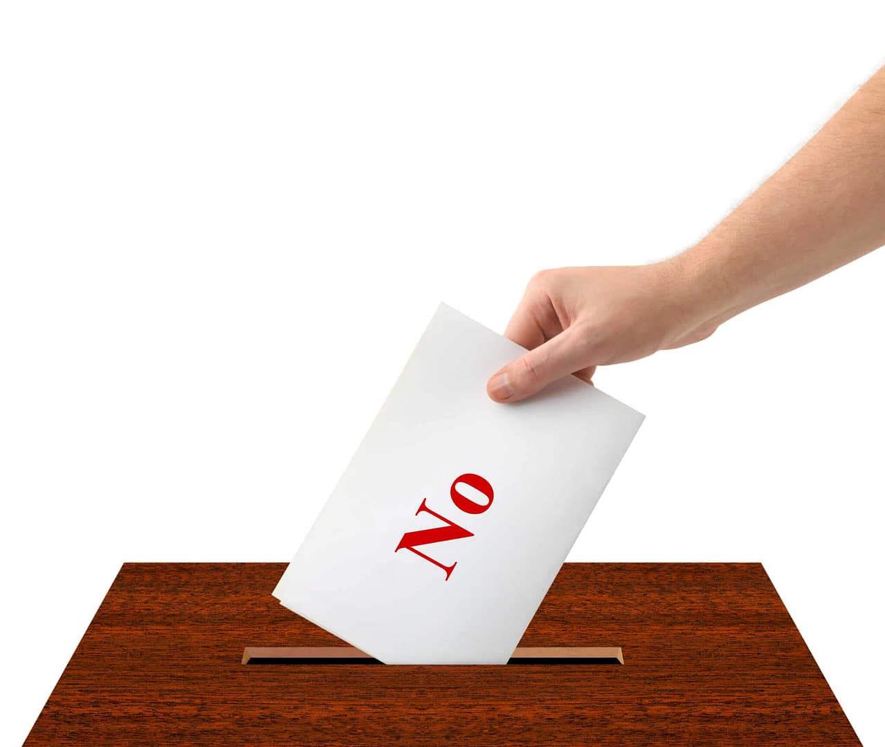 A hand putting a paper into a voting box at a committee meeting.