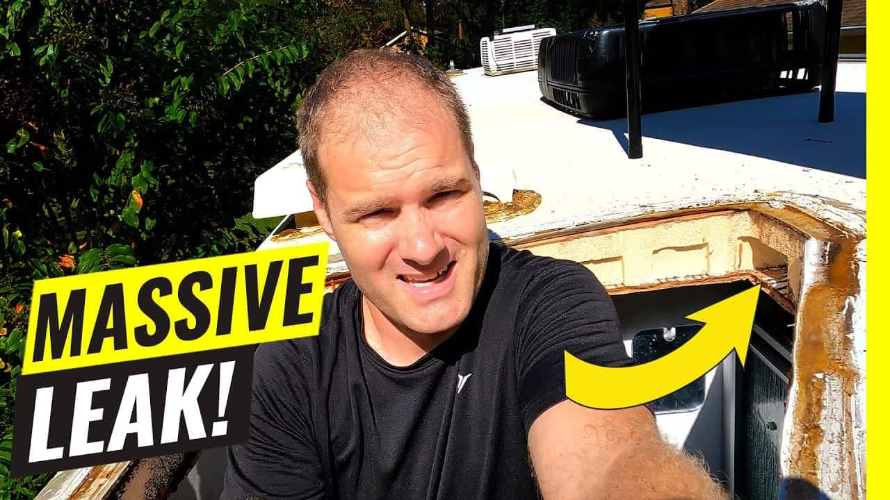 A man is capturing a picture of a significant leak in his RV, raising concerns about the effectiveness of the RV roof sealing.